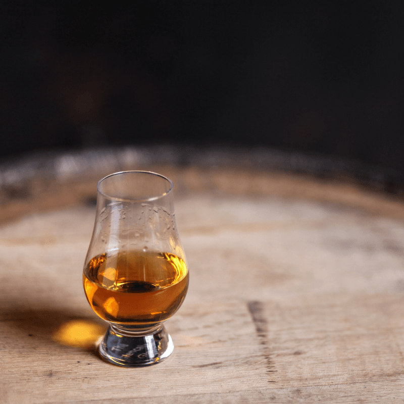 Dram of Scotch whisky on top of cask