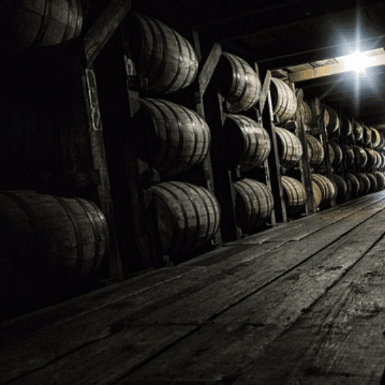 Spirits being cask finished in dark warehouse