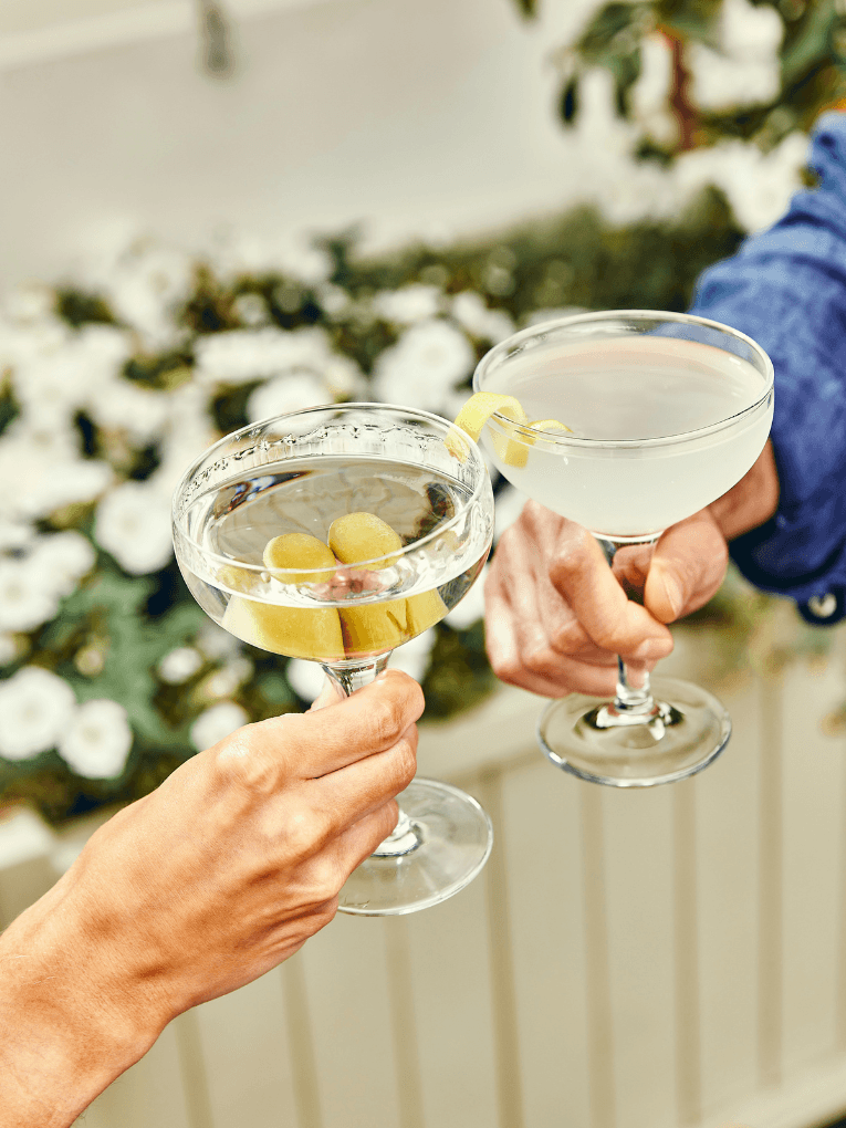 2 vodka martinis being clinked
